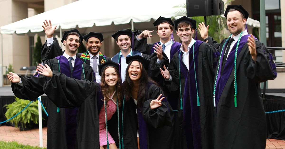 Graduates wave in front of the Law School