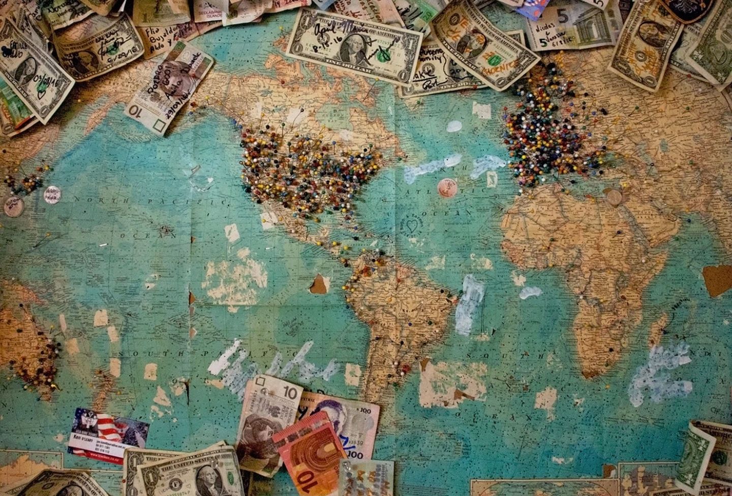 World map with money and pushpins
