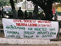 A sign calls for former Liberian president Charles Taylor to be indicted for war crimes. 